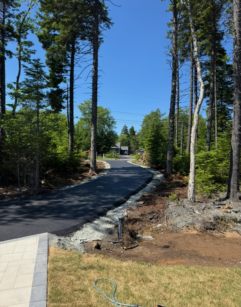 Freshly paved winding driveway through a wooded Nova Scotia property