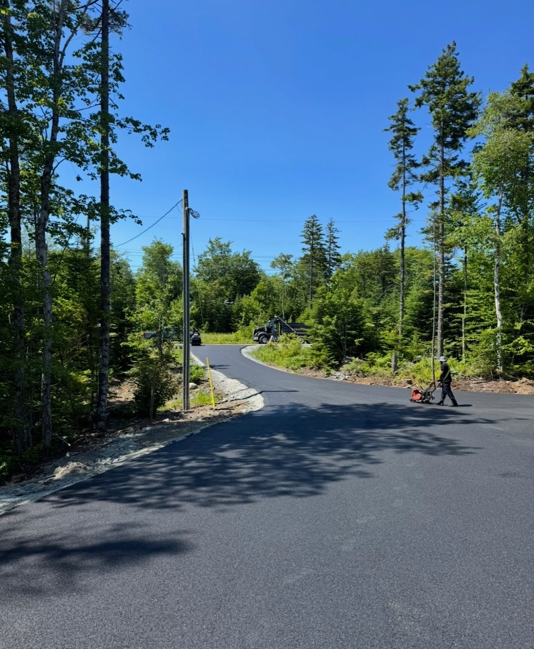 Long asphalt driveway resurfaced by Empire Paving